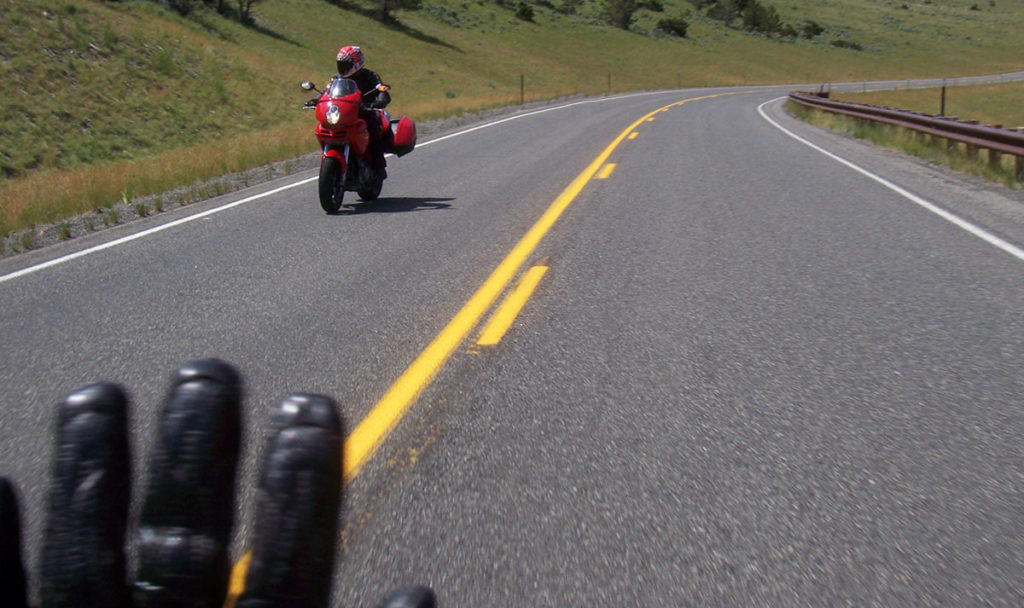 Waving to other motorcycle rider